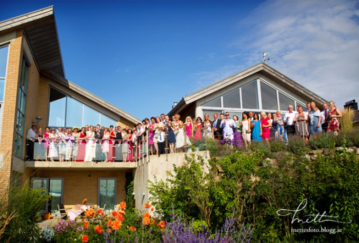 Wedding attendees grouped on balcony